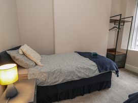 A bedroom with a bed and wardrobe at Llety Cllyd in Barmouth