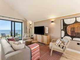 A living room with a television and sofa at Clifftop House Hot Tub in St Ives