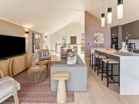 A living room with a television, sofa, and dining area at Clifftop House Hot Tub in St Ives