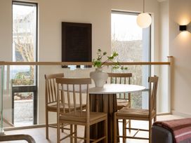 A dining room with a table and chairs at Clifftop House Hot Tub St Ives
