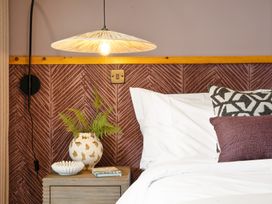 A bedroom with a bed and side table at Clifftop House Hot Tub, St Ives