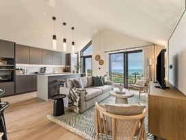 A living room with kitchen and ocean view at tbc in St. Ives