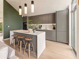 A kitchen with an island and bar stools at tbc in St. Ives