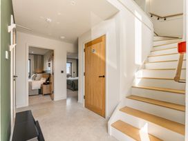 A hallway with a staircase and doors at tbc in St. Ives