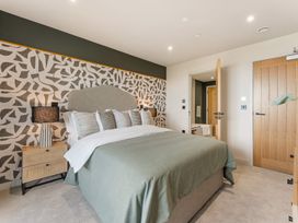 A bedroom with a bed and nightstand at tbc in St. Ives