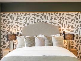 A bedroom with a bed and bedside tables at tbc in St. Ives