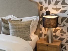 A bedroom with pillows and a lamp on a nightstand at tbc in St. Ives