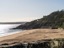 A beach view with cliffs and a house at Hidden 2- Bay House Hot Tub in St Ives