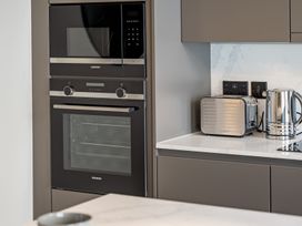 A kitchen with built-in oven and microwave at tbc in St. Ives