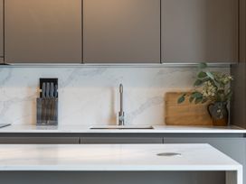 A kitchen with a sink and knife block at tbc St. Ives