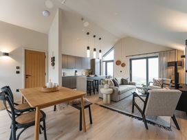 A living room and kitchen area with furniture at tbc in St. Ives