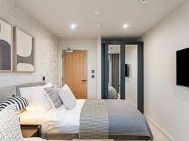 A bedroom with a bed and television at tbc in St. Ives