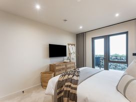 A bedroom with a bed and television at tbc in St. Ives