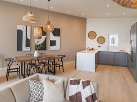 A living room with a dining area and kitchen at tbc in St. Ives