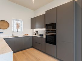 A kitchen with cabinets and appliances at tbc St. Ives