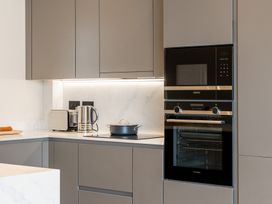A kitchen with modern appliances and cabinetry at tbc in St. Ives