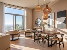 A dining room with a table and chairs at Hidden 9 – Grand Bay Suite Hot Tub St Ive