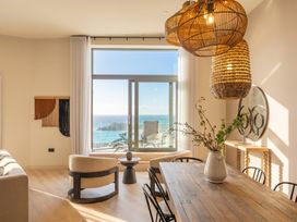 A dining room with a view of the ocean at Hidden 9 – Grand Bay Suite Hot Tub in St Ive