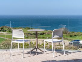 A table and chairs on an outdoor terrace overlooking the sea at tbc in St. Ives