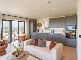 A living room with a kitchen area and dining table at tbc in St. Ives