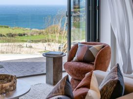 A living room with a chair and coffee table at tbc in St. Ives