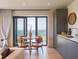 A kitchen with a table and chairs at tbc in St. Ives