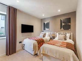 A bedroom with two beds and a television at tbc in St. Ives