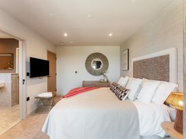 A bedroom with a bed and television at tbc St. Ives