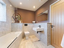 A bathroom with a bathtub sink and toilet at tbc in St. Ives