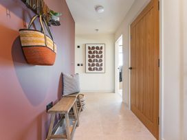A hallway with a bench and wall art at tbc in St. Ives