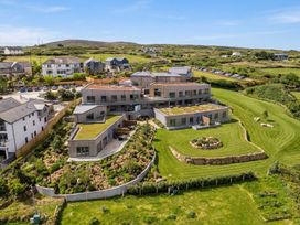 A view of a property surrounded by lawns and landscaping at Hidden 18- St Ives Bay Suite Hot Tub in St Ives