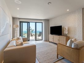 A living room with a sofa and television at tbc in St. Ives