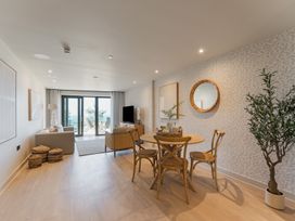 A living room with a dining table and sofa at tbc in St. Ives