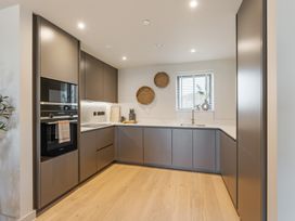 A kitchen with cabinets and appliances at tbc in St. Ives