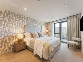 A bedroom with a bed and bedside table at tbc in St. Ives