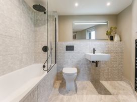 A bathroom with a bathtub, sink, and toilet at tbc in St. Ives