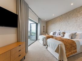 A bedroom with two beds and a television at tbc in St. Ives