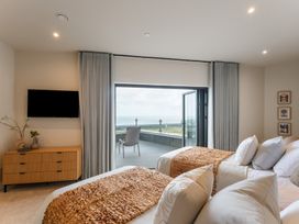 A bedroom with two beds and a television at tbc in St. Ives