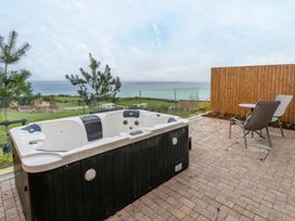 An outdoor area with a hot tub and chair at tbc in St. Ives