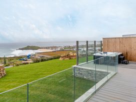 An outdoor area with a hot tub and grass overlooking the sea at tbc in St. Ives
