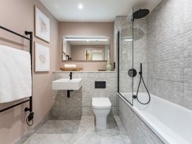 A bathroom with a bathtub, sink, and toilet at tbc in St. Ives