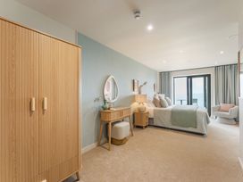 A bedroom with a bed and wardrobe at tbc in St. Ives