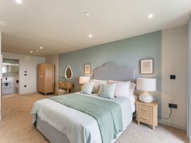 A bedroom with a bed and wardrobe at tbc in St. Ives