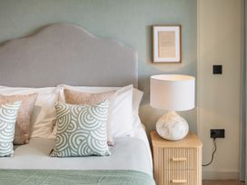 A bedroom with bed and bedside table at tbc in St. Ives