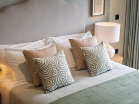 A bedroom with a bed and pillows at tbc St. Ives