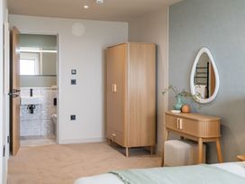 A bedroom with a wardrobe and vanity at tbc in St. Ives