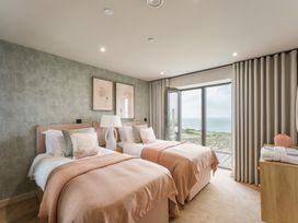 A bedroom with two beds and a view of the sea at tbc in St. Ives