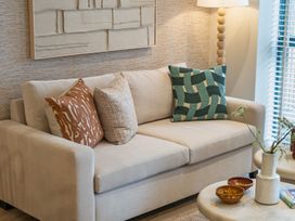 A living room with a sofa and decor at Hidden 19- Coastal Hot Tub in St Ives