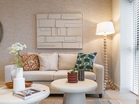 A living room with a sofa and coffee table at Hidden 19- Coastal Hot Tub in St Ives