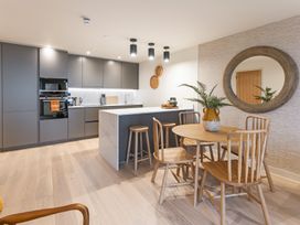 A kitchen with a table and chairs at Hidden 19- Coastal Hot Tub in St Ives